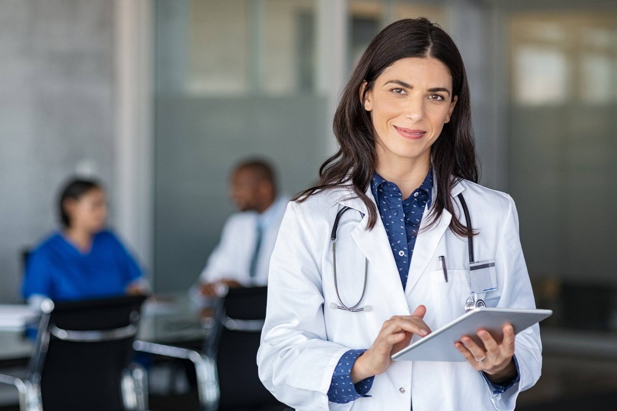 Doctor holding digital tablet at meeting room Doctor holding digital tablet at meeting room