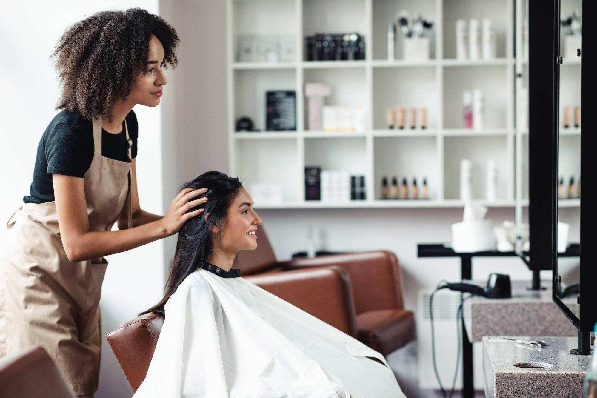 Young woman looking for changes, trying new hairstyle at beauty salon